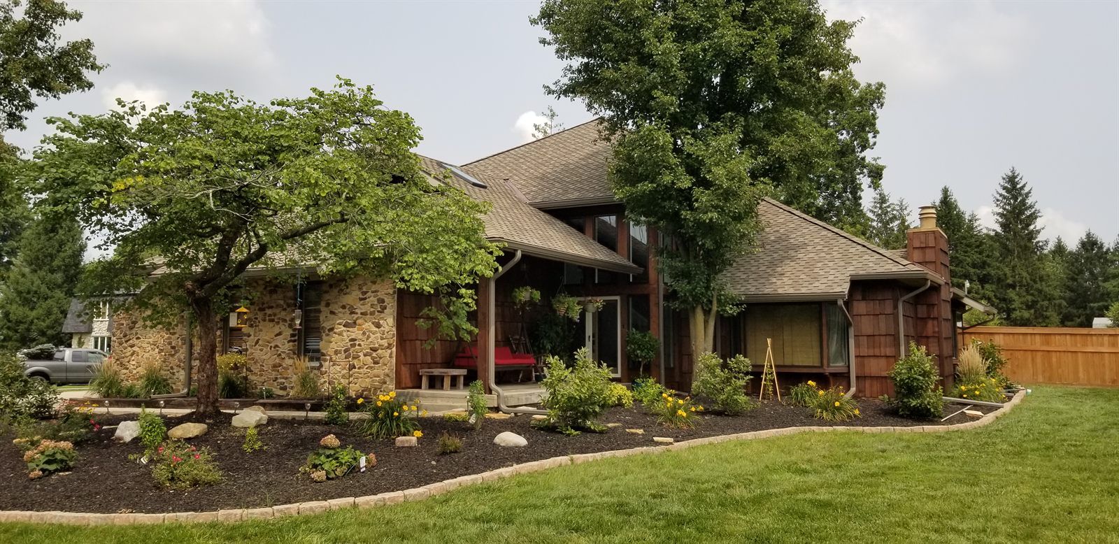 New architectural shingle roof on a stone-and-cedar Indiana home by Kingdom Roofing Systems