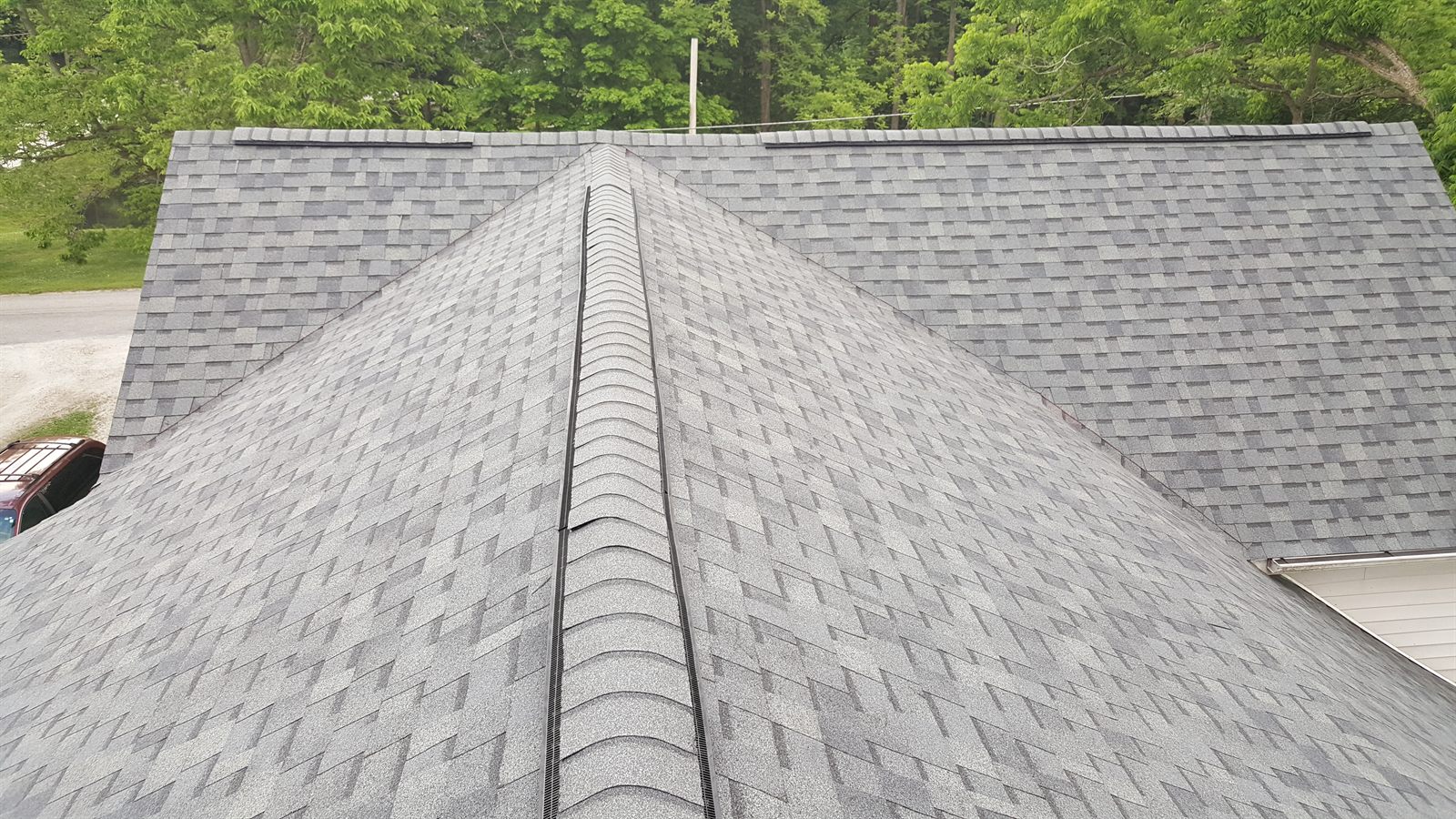 Close-up of a completed architectural shingle roof and ridge vent by Kingdom Roofing Systems