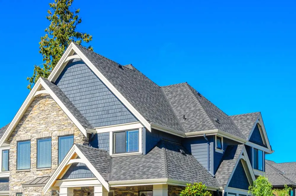 GAF Timberline HDZ architectural asphalt shingle roof on a stone-and-siding home
